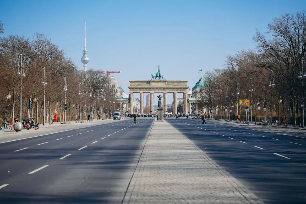 Panoramic view of the Brandenburg Gate and Berlin TV Tower on a clear day.